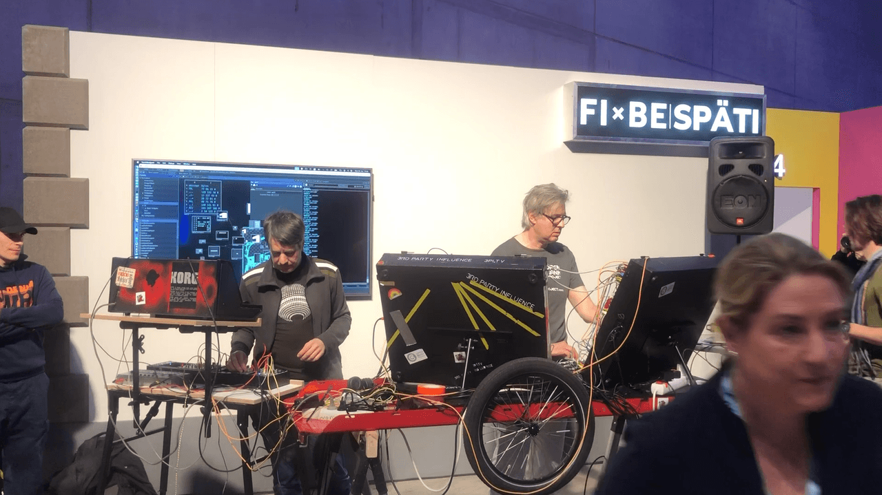 Daniel and Simon performing at FIBE 2024. The screen shows APIs being called by the sequencers.